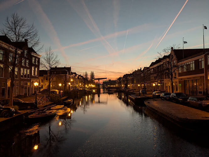 view of a city canal as the sun rises