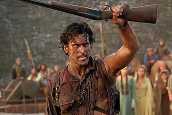 Screenshot from Army of Darkness. Ash, wearing a torn and bloodstained shirt with one arm torn off brandishes a sawn-off shotgun within a castle courtyard, whilst surrounded by a crowd of peasants.