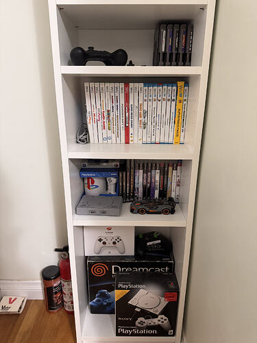 sodapone's retro game collection. The fourth shelf has NES games, the fifth shelf has Wii and Wii U games, the fifth shelf has PS1, PS2, and PS3 games, and the bottom shelf has boxes for a Stadia controller, Dreamcast, and PlayStation Classic.