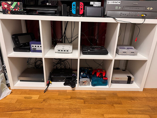 sodapone's retro console collection. Left to right, top to bottom: Wii U, GameCube, Dreamcast, Genesis, SNES, Xbox One X, Sega Saturn, Nintendo 64, NES.