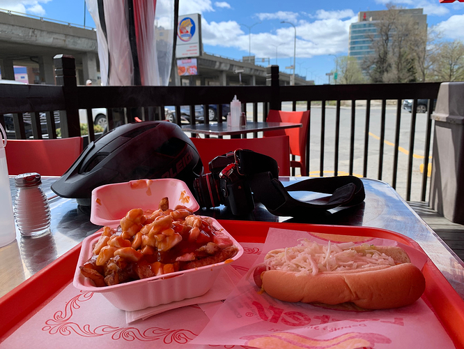 My film camera & bike helmet, next to a tray with the steamé-poutine.