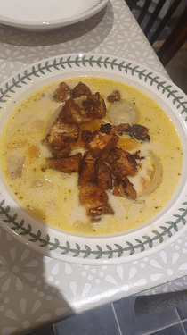 White soup with chicken on top