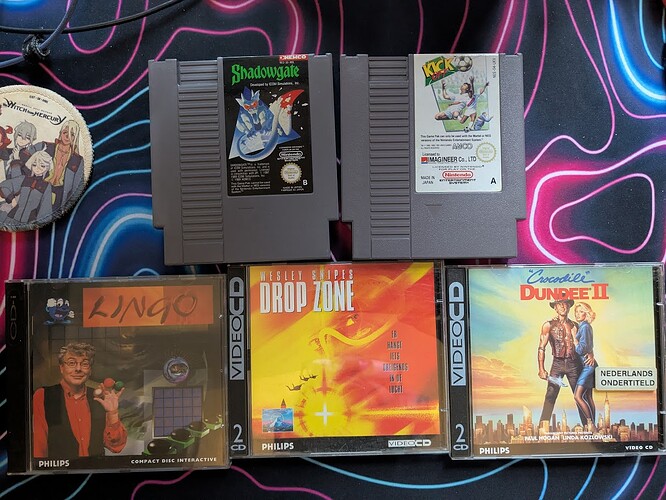 NES cartridges for Shadowgate and Kick-Off, CD-i case for Lingo, and Video CD cases for Drop Zone and Crocodile Dundee II