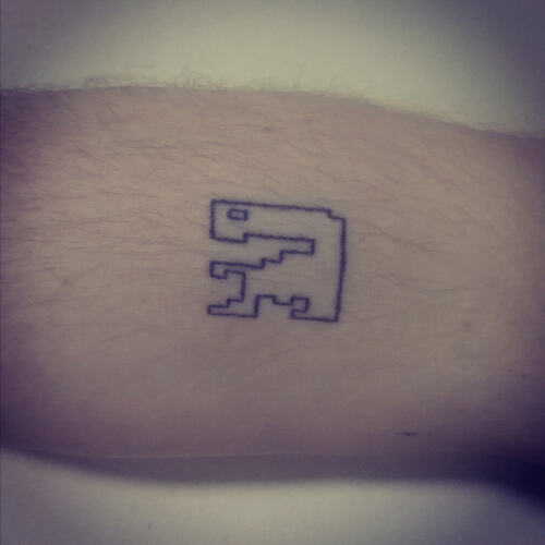 A stick and poke tattoo depicting the sprite from the Atari ET game with simple linework
