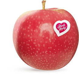 Photograph of a Pink Lady apple. It had reddish-pink skin with pale dots, and bears a heart shaped sticker specifying the brand name